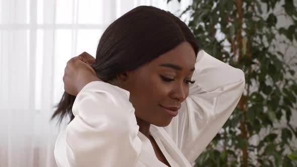 African American Woman Posing Doing Ponytail Enjoying Morning At Home