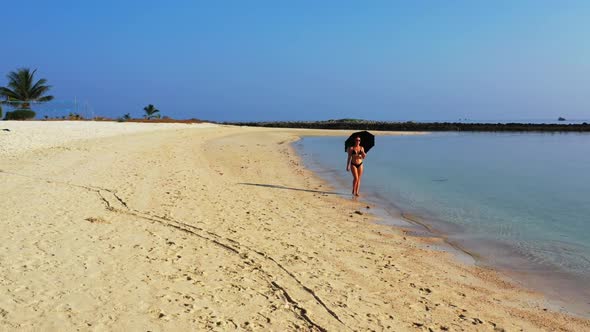 Tourists posing on perfect seashore beach time by turquoise lagoon and bright sandy background of Ko