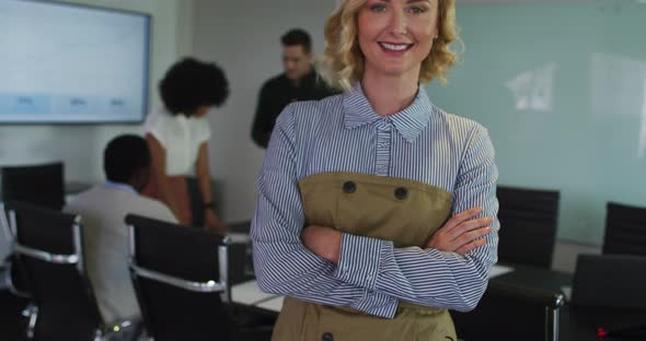 Portrait of caucasian businesswoman in meeting room looking to camera smiling