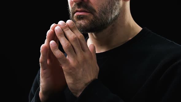 Sick Poor Man Praying to God Against Dark Background, Christianity, Belief