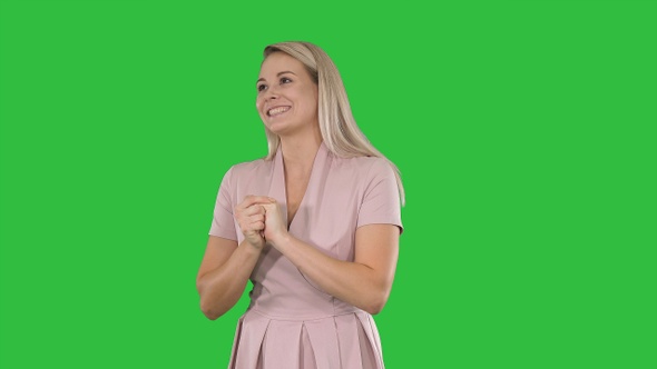 Woman in pink talking to the camera on a Green Screen, Chroma Key.