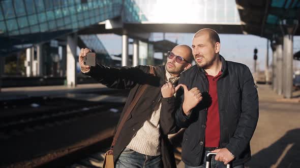 Two Men on the Platform of the Railway Station Waiting for the Arrival of the Train and Take