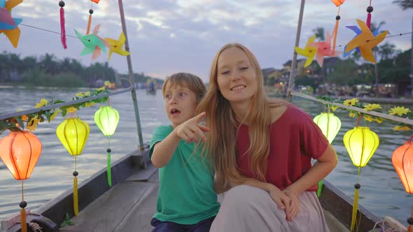 A Young Woman and Her Son Tourists Visit an Ancient Town of Hoi An in the Central Part of Vietnam