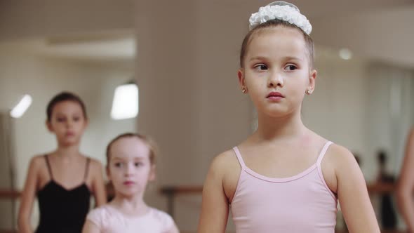 Little Modest Ballerina Girls Standing in the Studio on Training