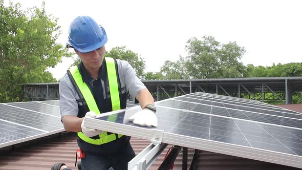 Asian technicians install panels Solar cells to produce and distribute electricity.