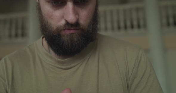 Close Portrait of Thoughtful Man Looking Seriously When Using Phone Indoors