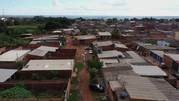 The dirt streets of the Sol Nascente favela with raw sewage in the streets - aerial view