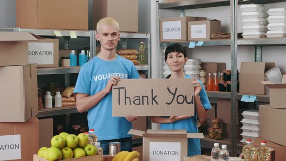 Volunteers Holding Banner with Text Thank you at Food Bank