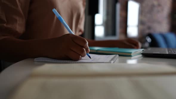 Closeup Hands of Unrecognizable African Businesswoman Using Laptop Writing Notes Sitting at Home