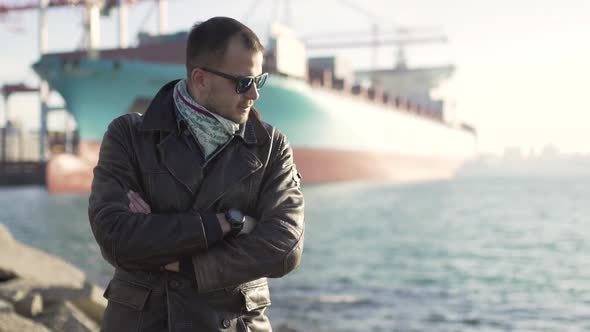 Portrait of Handsome Man in the Harbor at Cold Sunny Day