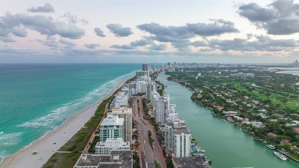 Forwards Fly Above Row of Tall Buildings on Seaside