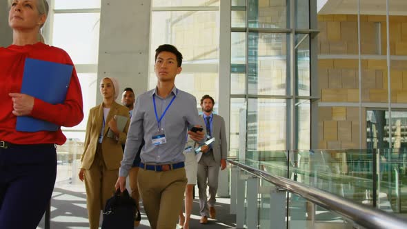 Business people walking in office building 4k