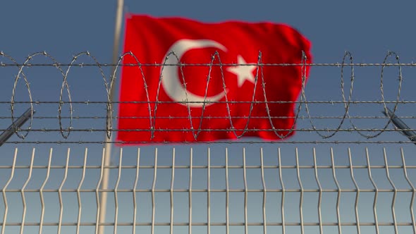 Barbed Wire Against Waving Flag of Turkey