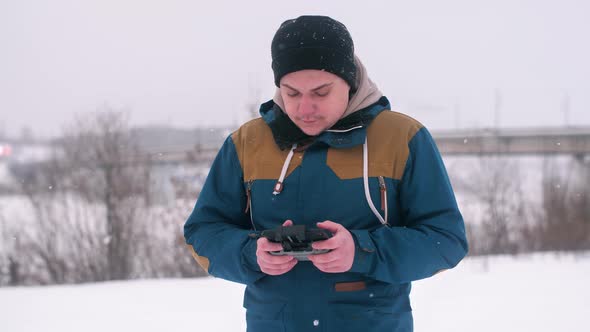 A Man Looks Into the Control Quadcopter