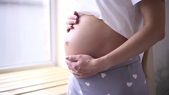 Mother Touching Stroking Belly with Future Baby Spbd