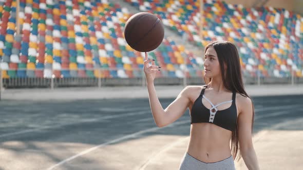 Young Sporty Girl Playing with a Sport Ball at a Stadium