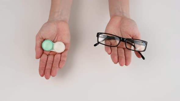 A Woman Makes a Choice Between Lenses and Glasses