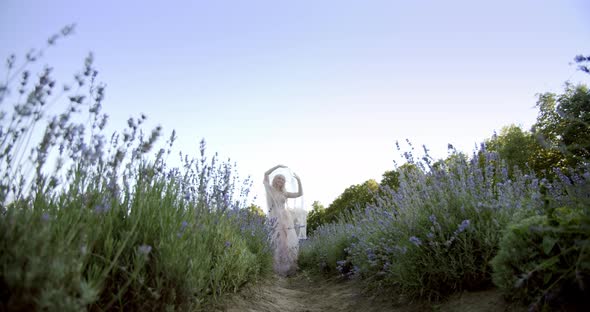 Cinematic View of Woman Dancing Colorful Lavender Fields on a Sunny Day Blooming Purple Flowers. V2