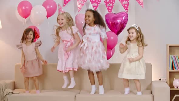 Amazingly Beautiful Little Girls Jumping on Sofa