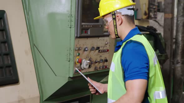 Smart Factory Worker Using Machine in Factory Workshop