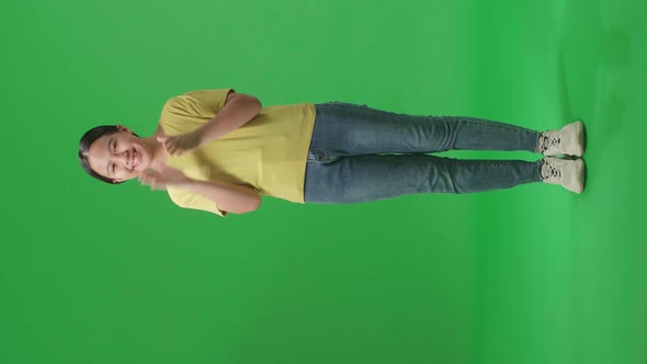 Full Body Of Young Asian Kid Girl Clapping Her Hands In The Green Screen Studio