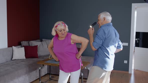 Senior Couple Dancing Laughing at Home. Grandparents Relaxing Having Fun Celebrating Anniversary