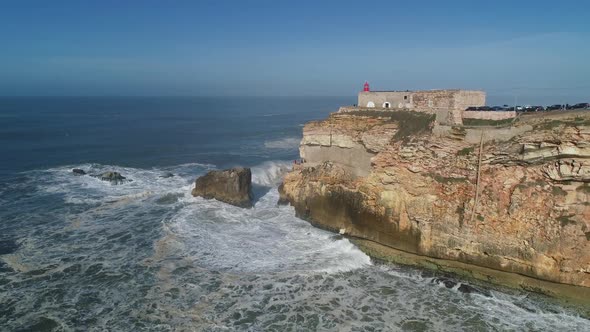 Lighthouse on Cliff on Atlantic Ocean in Nazare