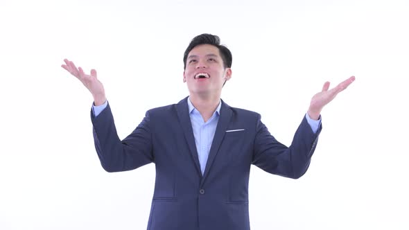 Happy Young Asian Businessman Catching Something