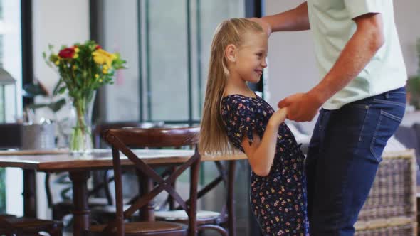 Father and daughter dancing together