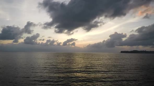 Beautiful timelapse of an orange sunset with forming clouds up above