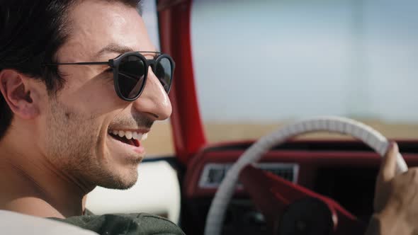 Close up video of happy laid man driving a stylish car. Shot with RED helium camera in 8K