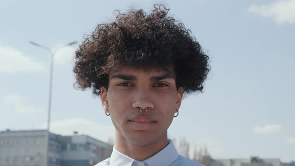 Close Up Young Fun African Man Curly Hair 20s Years Old Wears Blue White Shirt Posing Looking Camera