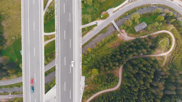 Aerial Top View of Highway Viaduct with Multilane Traffic in Mountains. Autobahn in Austria