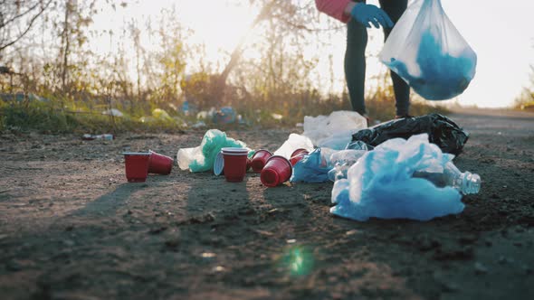 Care About Nature. Volunteer Girl Collects Trash in the Trash Bag. Trash-free Planet Concept. Nature