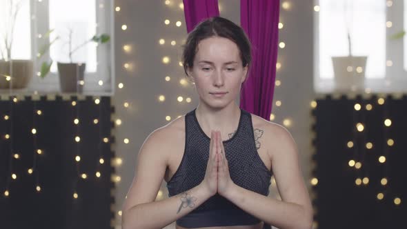 Young Pretty Woman Stretching Her Leg Using Yoga Hammock