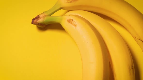 Fresh Bananas on a Yellow Minimalistic Background
