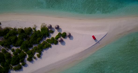 Wide angle drone abstract shot of a white sandy paradise beach and turquoise sea background in vibra