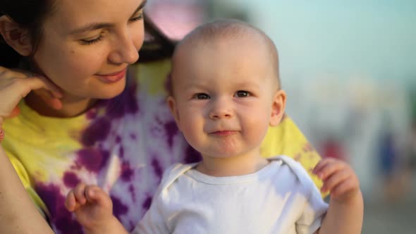 Mom and Her Little Son are Relaxing in the Park