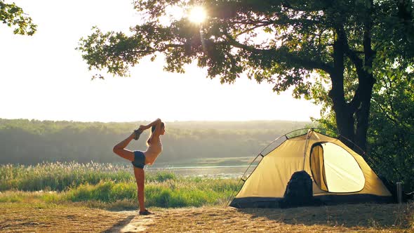 Woman Doing Yoga in a Front of Tent