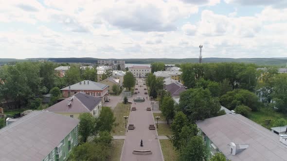 People walks along a beautiful alley in a provincial town. Aerial 02