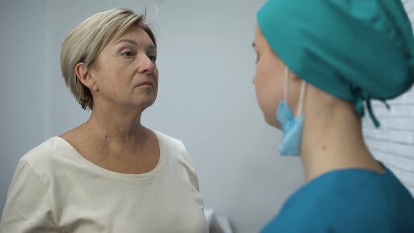 Female Nurse Telling Patient Bad Diagnosis, Disappointing News, Woman Crying