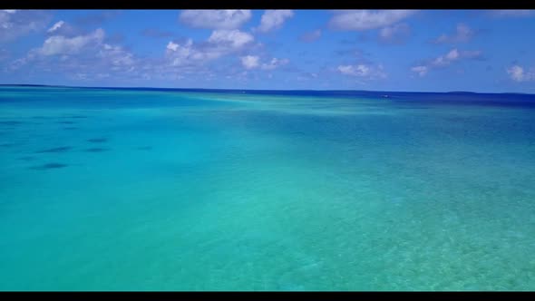 Aerial drone shot tourism of idyllic coastline beach holiday by aqua blue sea and clean sand backgro