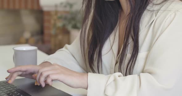 Close-up of Female Caucasian Hands Typing on Laptop