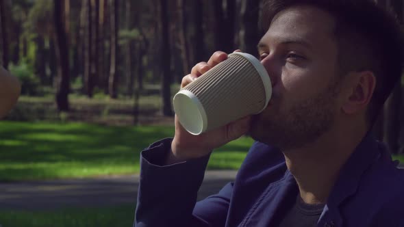 Beautiful Guy and Girl Have Breakfast at the Open Air