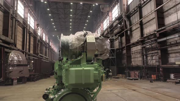 Powerful Engine on Floor Near Repaired Vessel in Dock