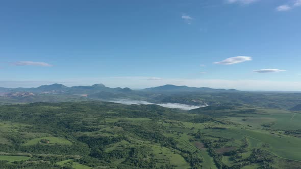 Blue sky above valley of Carpathian mountain ranges in Eastern Serbia 4K aerial video