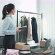 Young asian entrepreneurs check their clothes before selling them to customers. - VideoHive Item for Sale