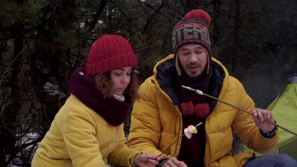 Young Man and Woman on a Picnic in the Winter Forest