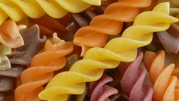 Colored italian fusilli raw pasta